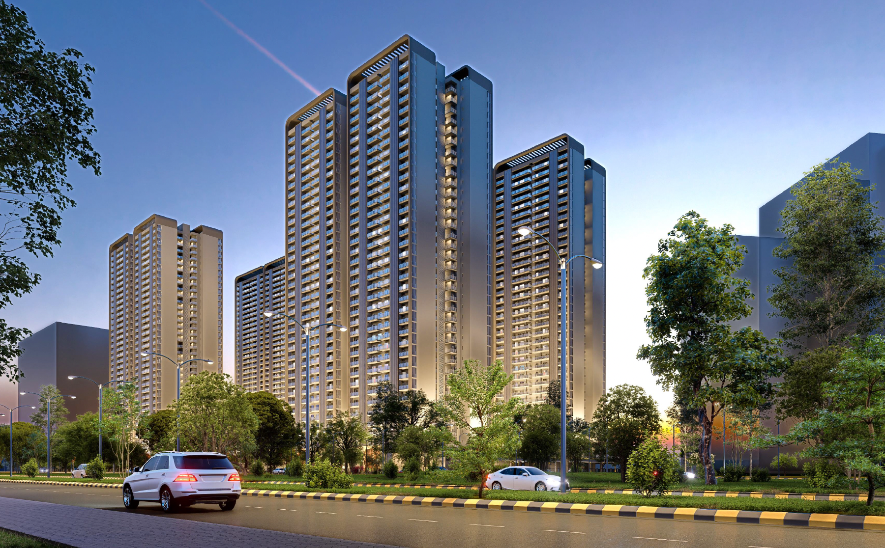 Forbes Fab Luxe Residences towers viewed from the road approach at dusk, with landscaped grounds and warm golden lighting